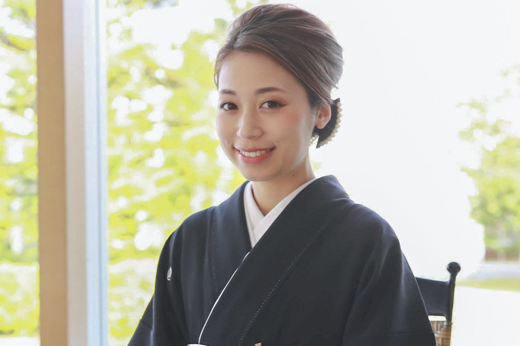 おでこを前髪で隠さない髪型の黒留袖の女性